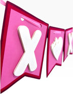 Paper Party Studio XOXO banner with white layered letters on pink and red flags, tied with red satin ribbon.
