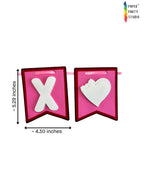 Paper Party Studio XOXO Valentine's bunting with pink and red cardstock flags, white heart cutouts, and satin ribbon.