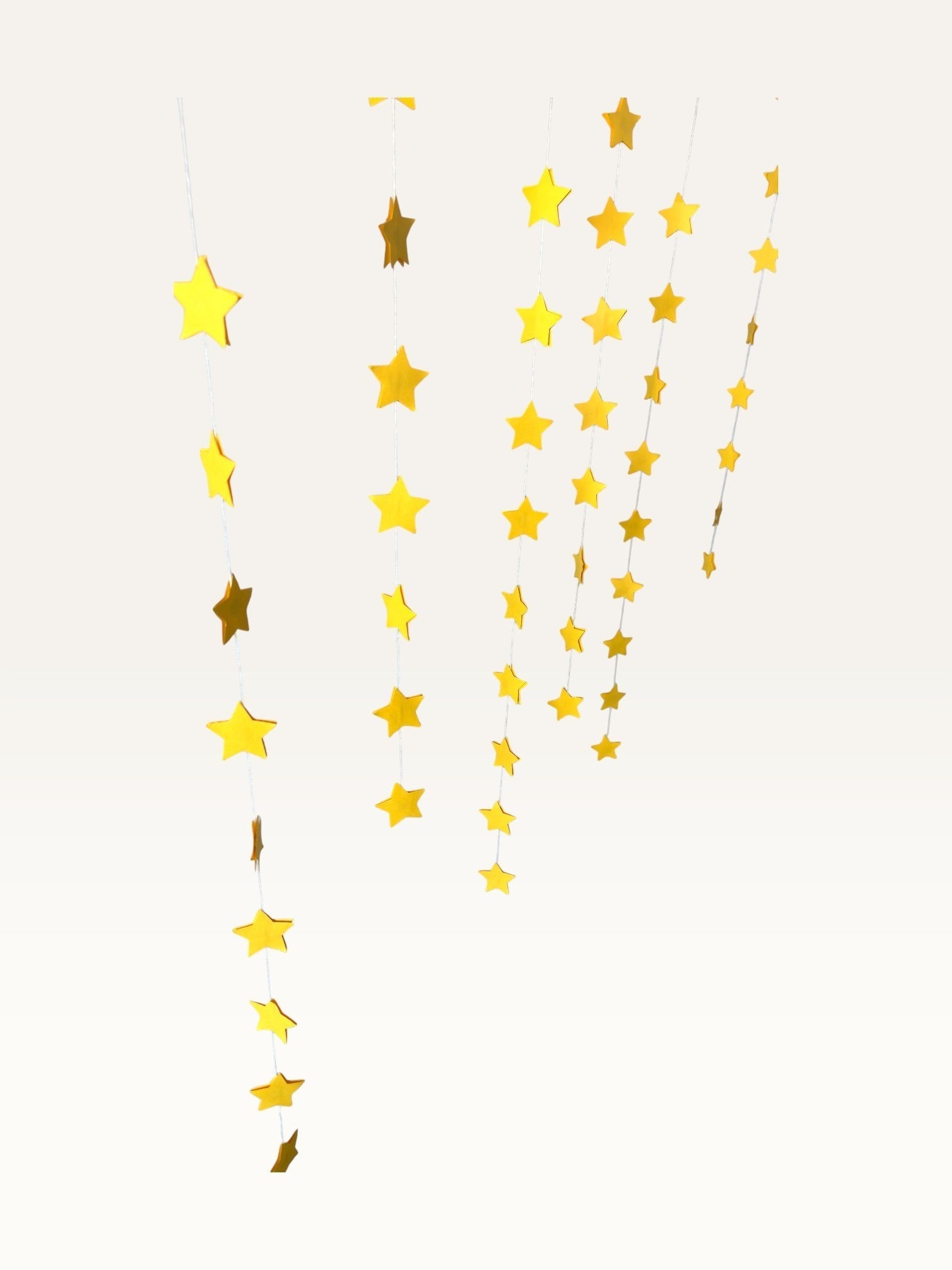 Paper Party Studio set of 10 yellow paper star garland strings for hanging party decorations and backdrops